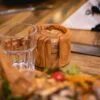 5_94e22328-9b82-440d-9385-44e3170b20d9 مجموعة من 6 أقراص تحت الأكواب من خشب الزيتون مع حامل أقراص