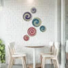 coffee_shop_1x1_cf29ca73-0032-4167-b7e8-c840ce919a53 مجموعة من 6 أقراص حائطية زخرفية. مصنوعة يدوياً من الحلفاء التونسية